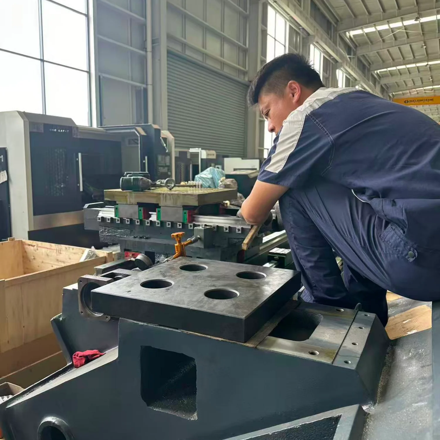 Engineer is adjusting the accuracy of the CNC lathe bed